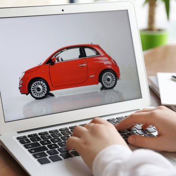 usaa extended car warranty typing on laptop red car on monitor